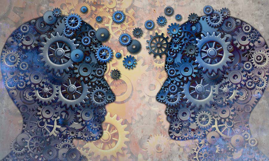 Two illustrative heads facing each other with gears and thoughts moving between them