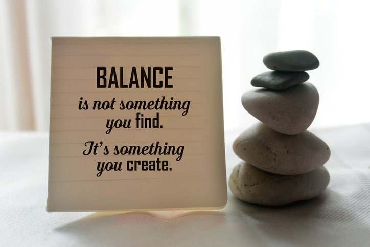 Balance message with calming rocks in pile