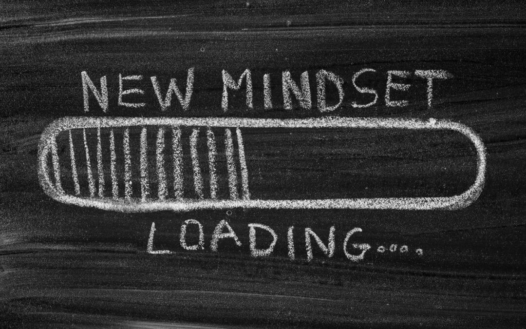 blackboard with white chalk writing with new mindset loading and bar showing