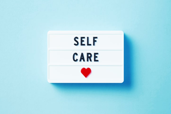 sign with the words Self Care and red heart