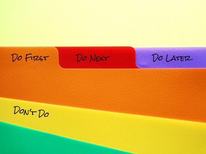 Colorful file folders with Do first, do later type messaging